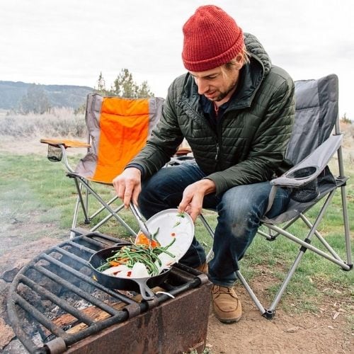 Michael cooking over a campfire