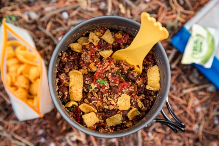 A backpacking pot filled with a burrito bowl backpacking meal