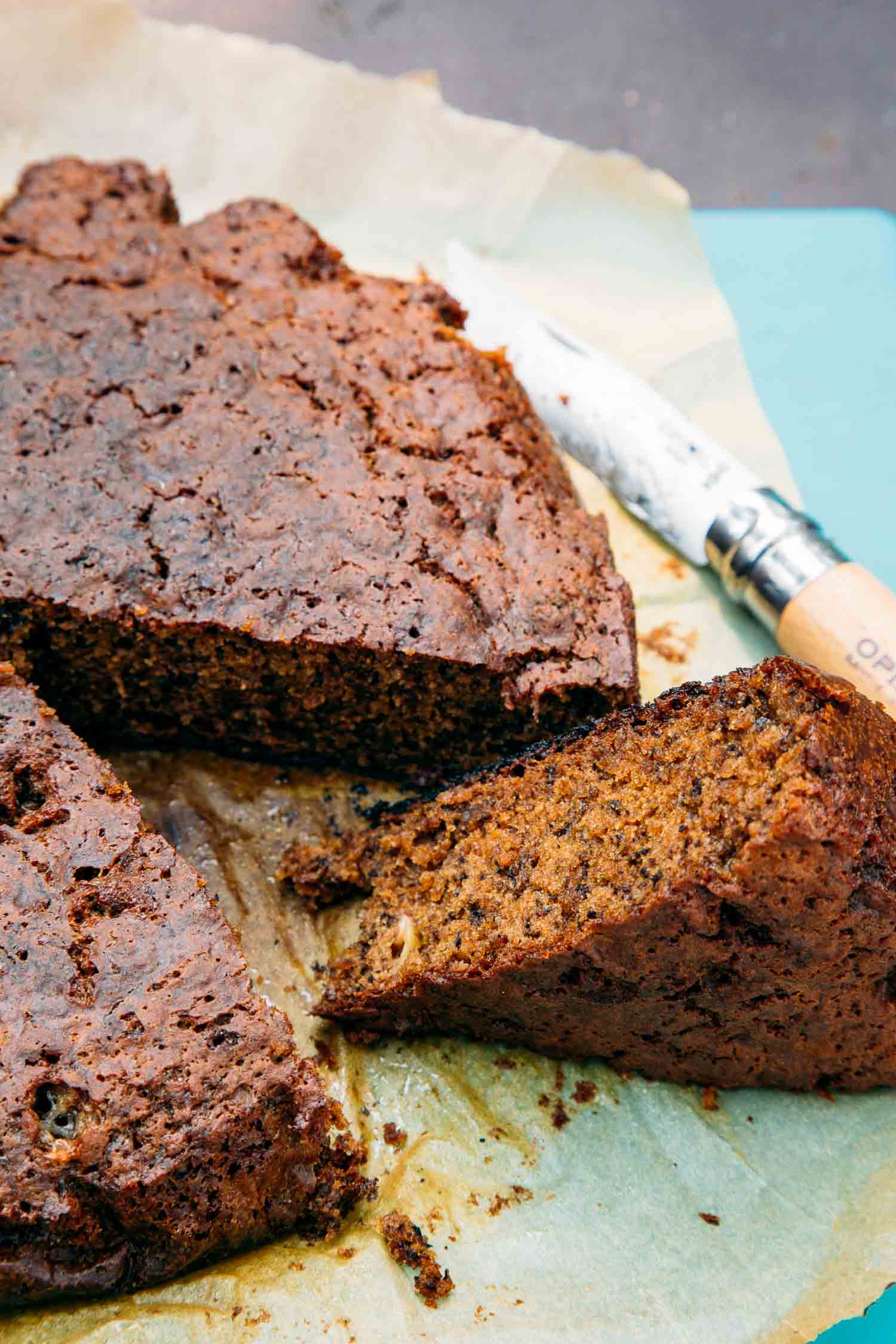 Side view of a loaf of banana bread with a slice cut out.