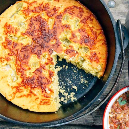 Cornbread in a Dutch oven with a slice taken out