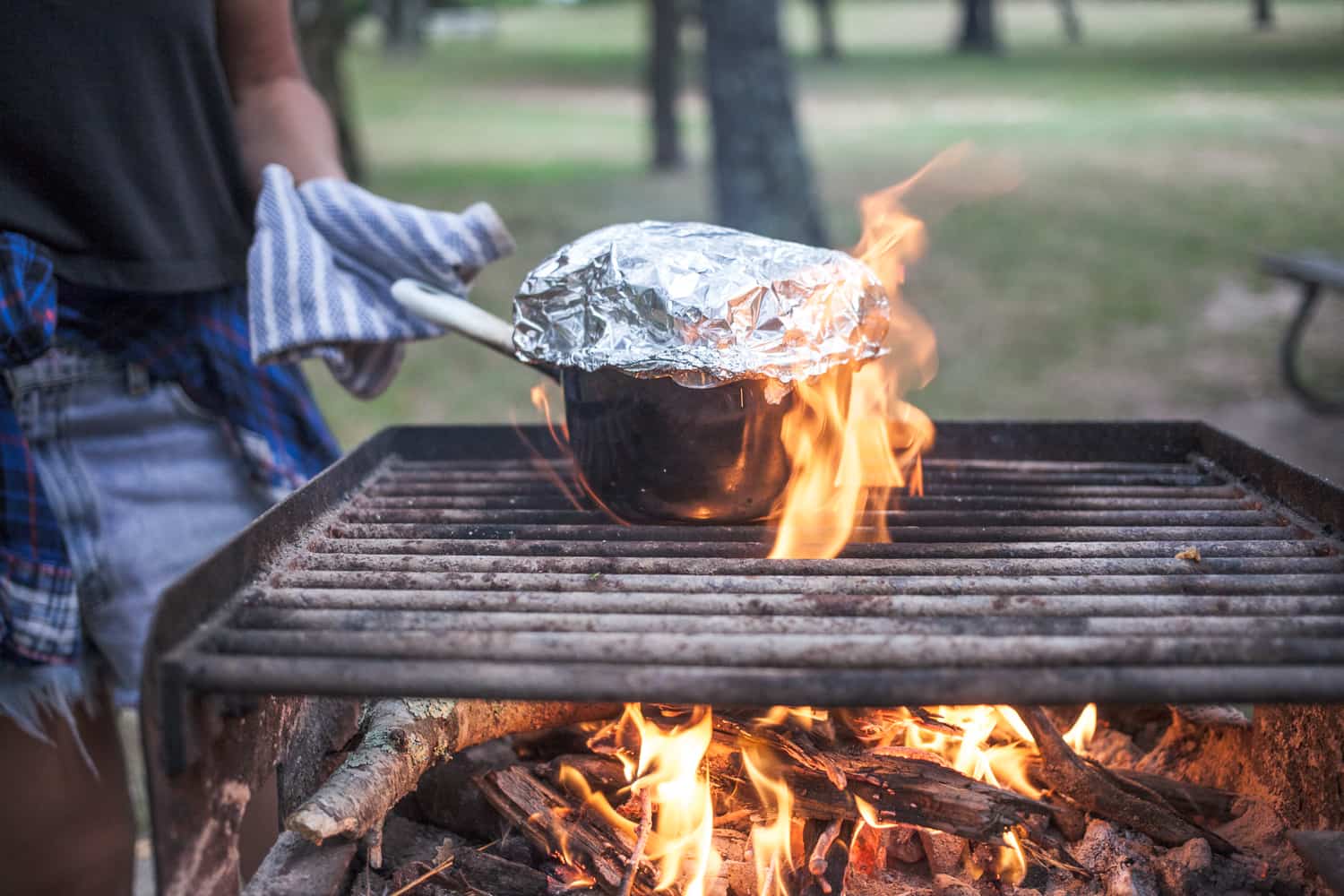 Popping popcorn over a campfire.