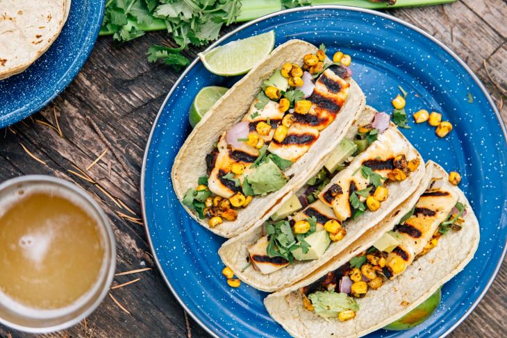 Three halloumi tacos on a blue camping plate