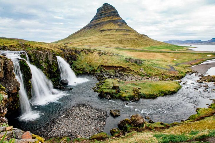 The Kirkjufellsfoss waterfall with the Kirkjufell mountain in the distance