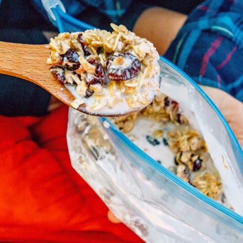 Megan with a spoonful of granola next to a bag of granola