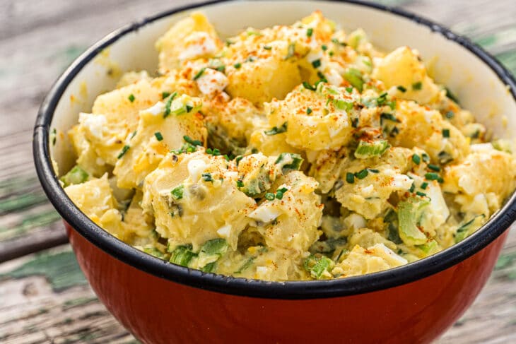 Potato salad in a red serving bowl