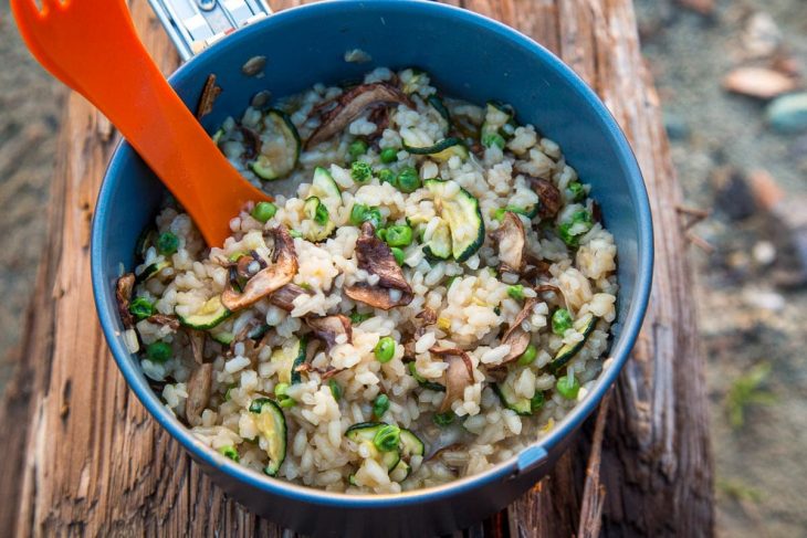 A pot of risotto on a log