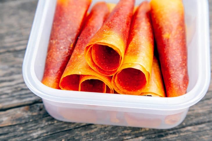 Mango Strawberry fruit leathers stacked in a container